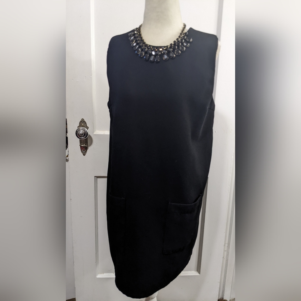 Sleeveless black pocket-front shift dress